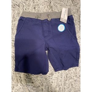 Boys pull on blue shorts